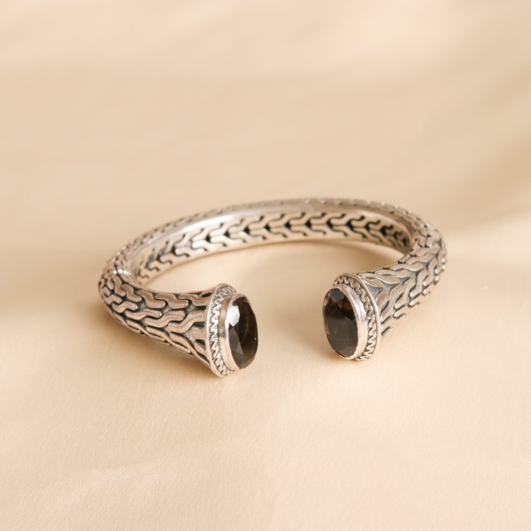 Silver bangle with set black stones