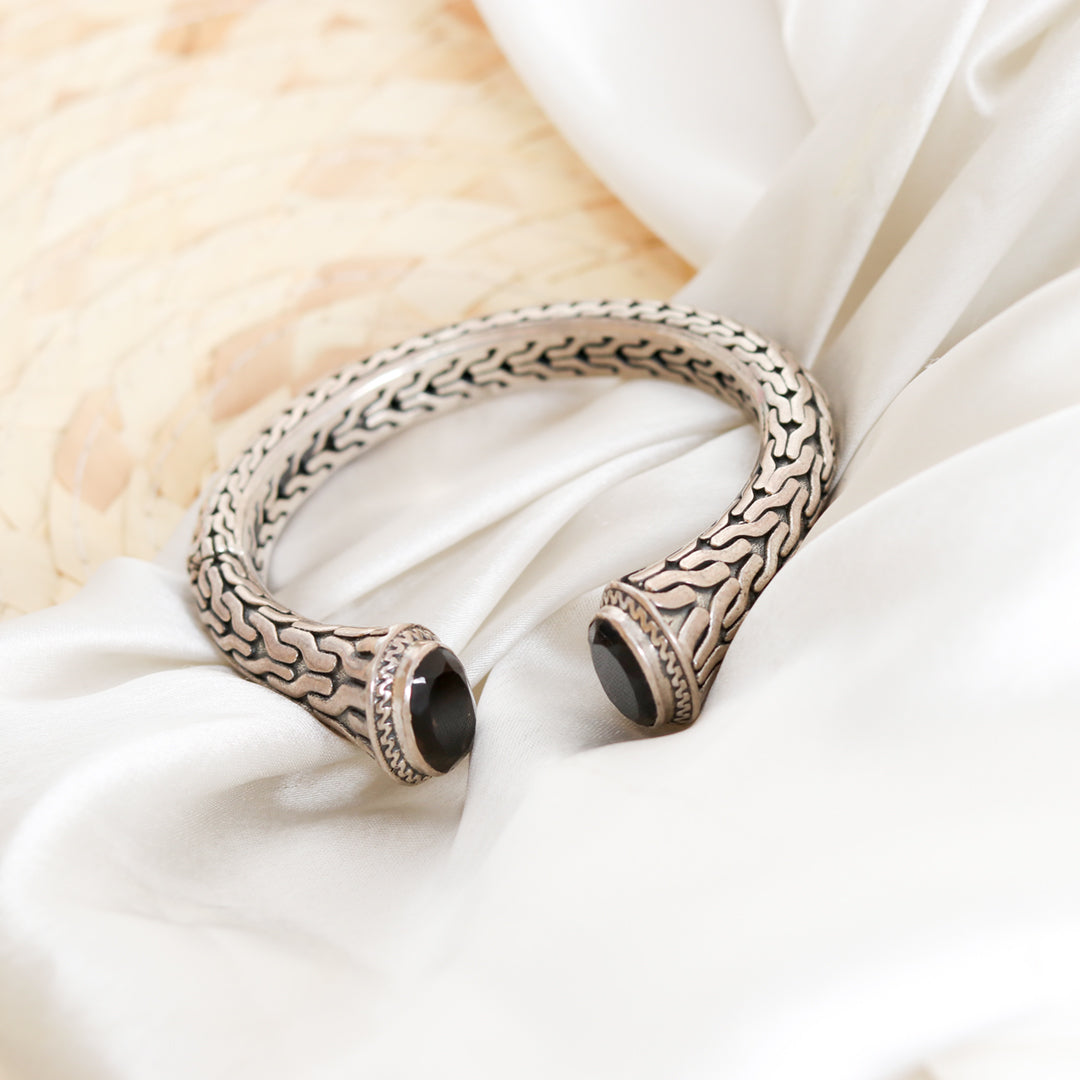 Silver bangle with set black stones