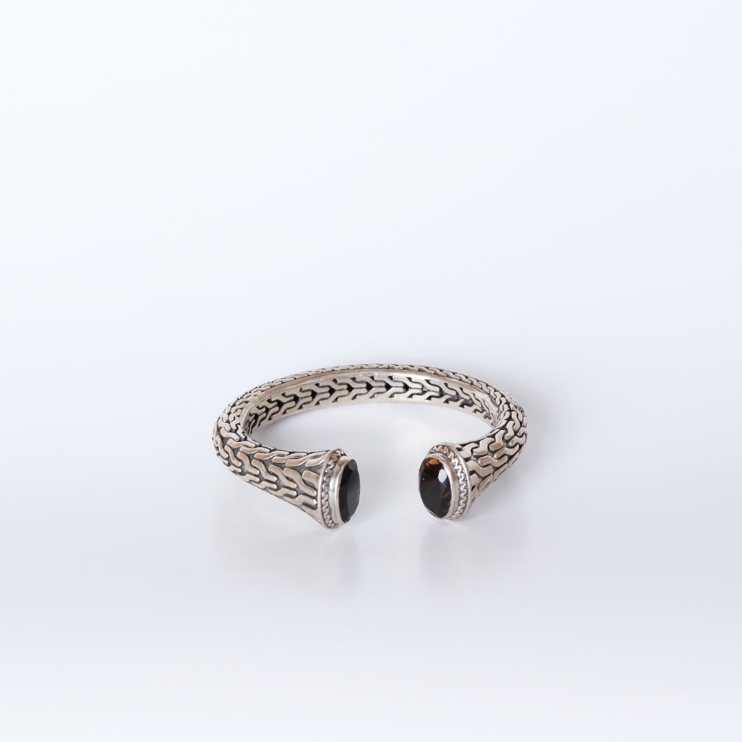 Silver bangle with set black stones