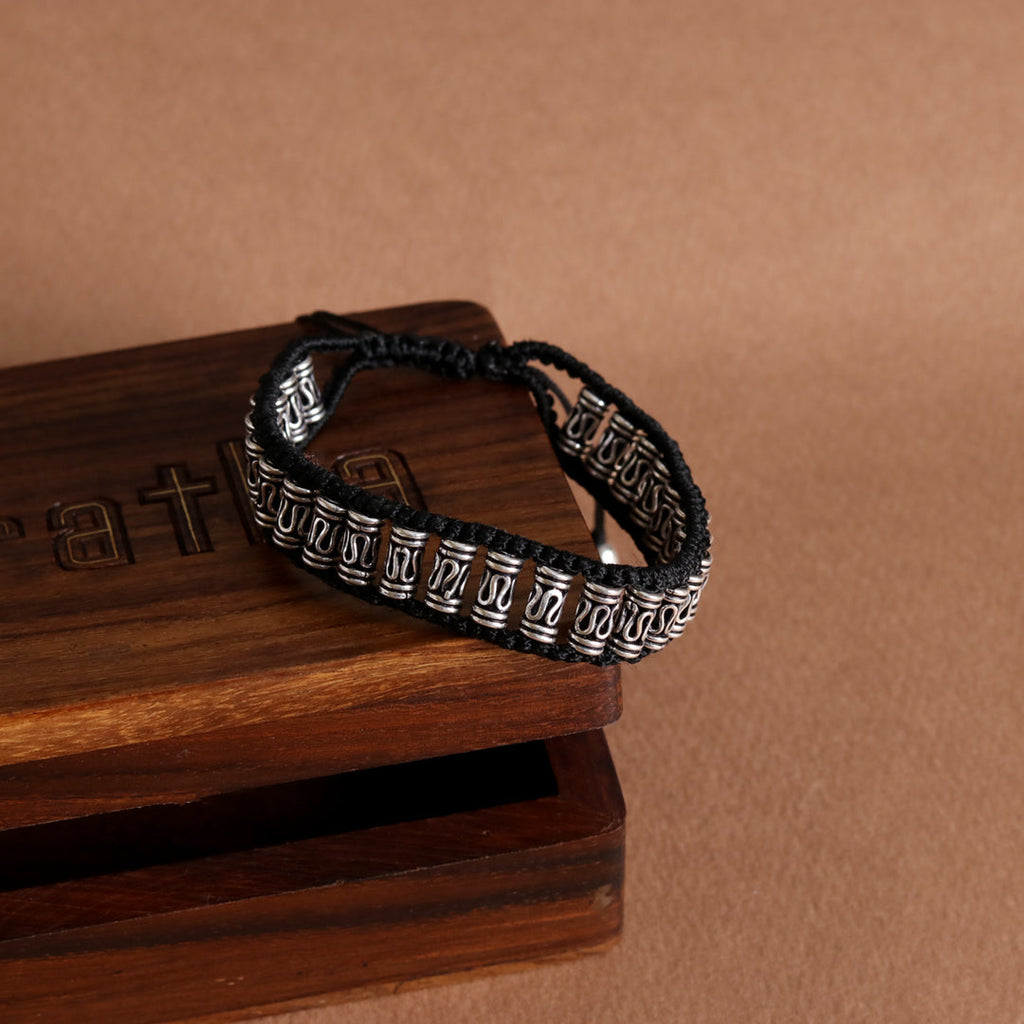 Elegant bracelet – handcrafted with silver motifs and black braiding