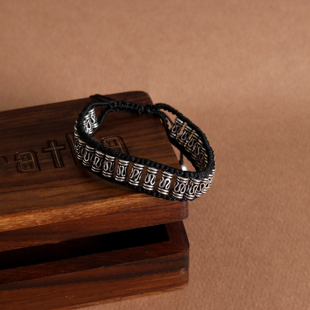 Elegant bracelet – handcrafted with silver motifs and black braiding