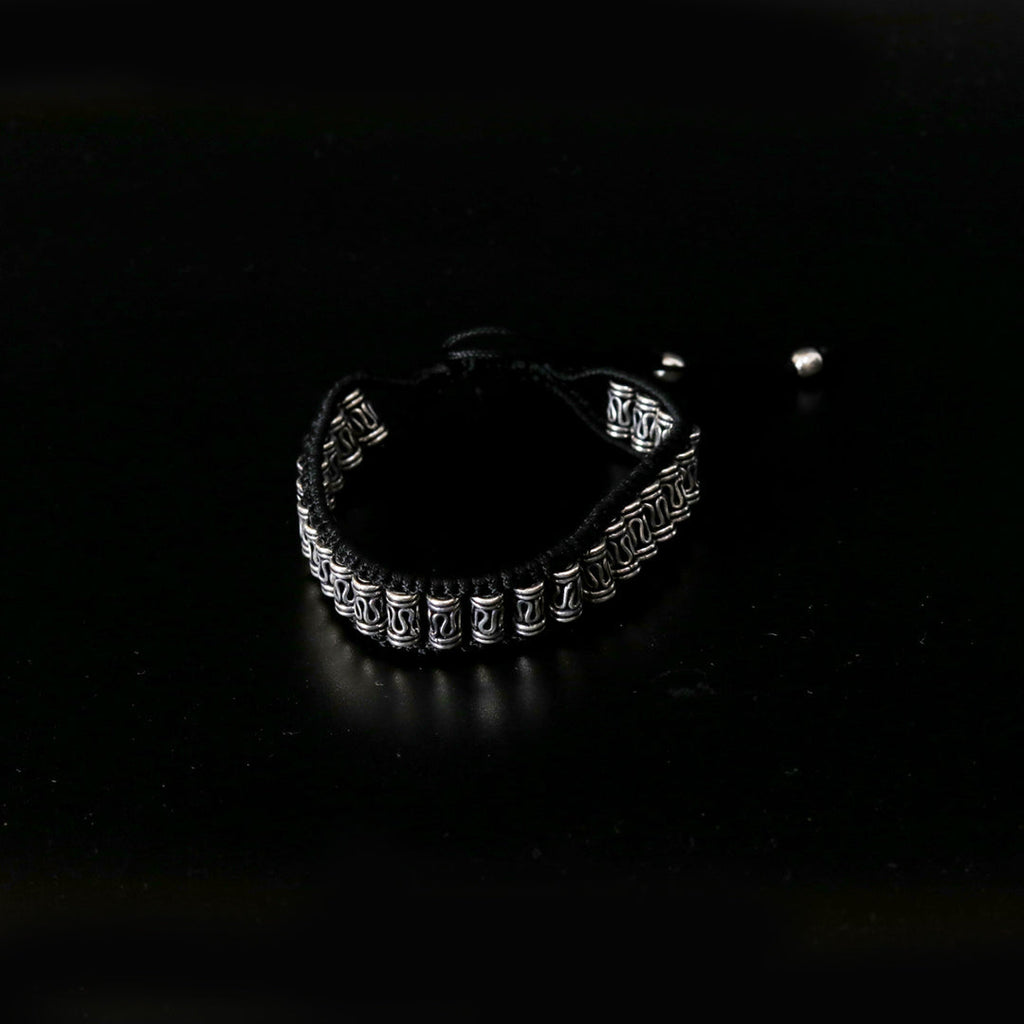 Elegant bracelet – handcrafted with silver motifs and black braiding